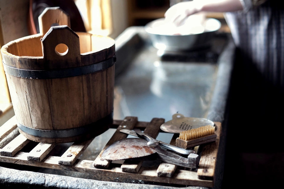 Wooden cleaning brush and kitchen washing tools near a sink