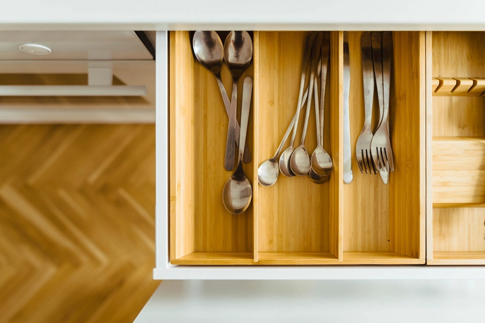 Kitchen drawer with utensils arranged in wooden compartments